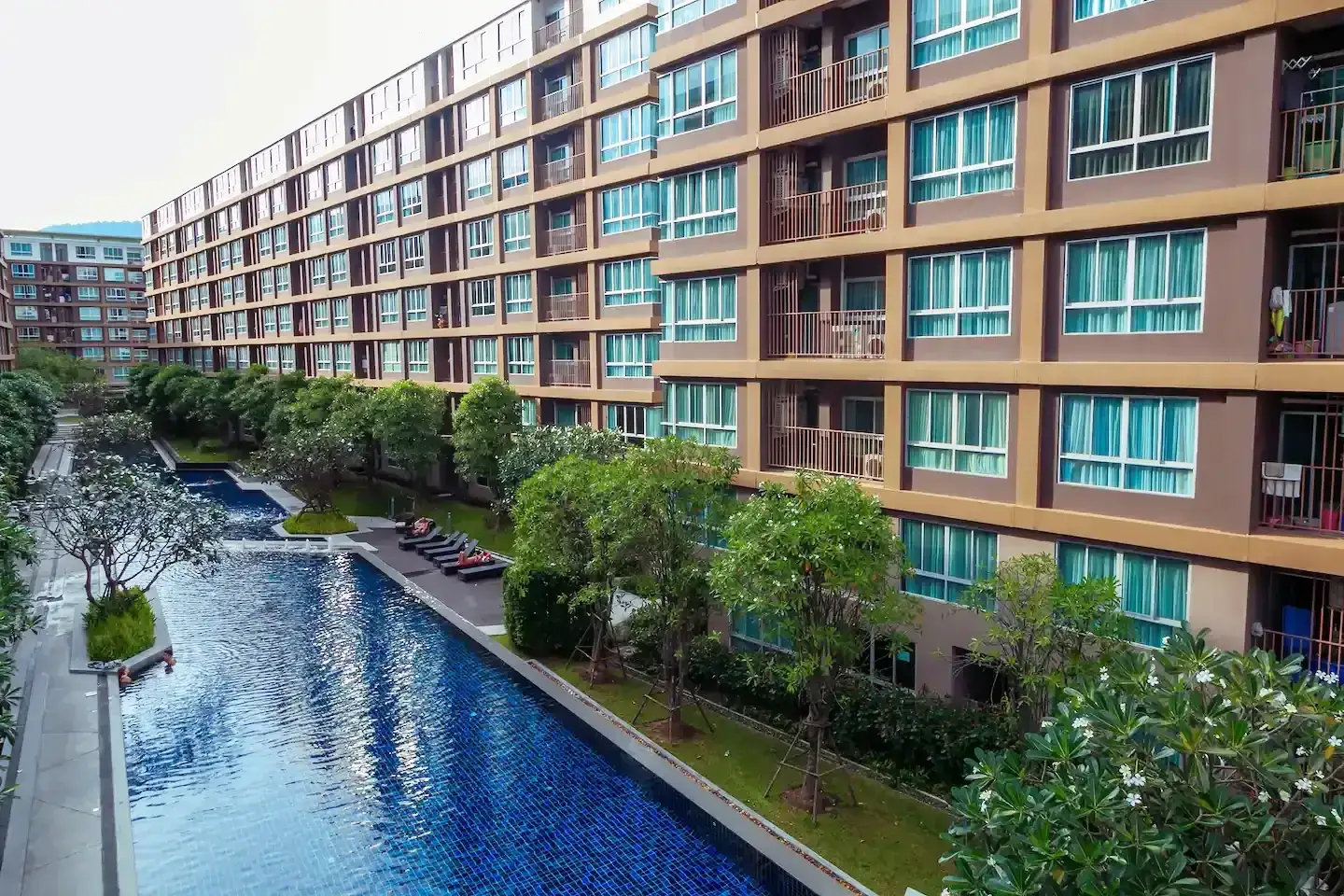 Outdoor saltwater lagoon pool and tropical gardens at D Condo Creek Phuket