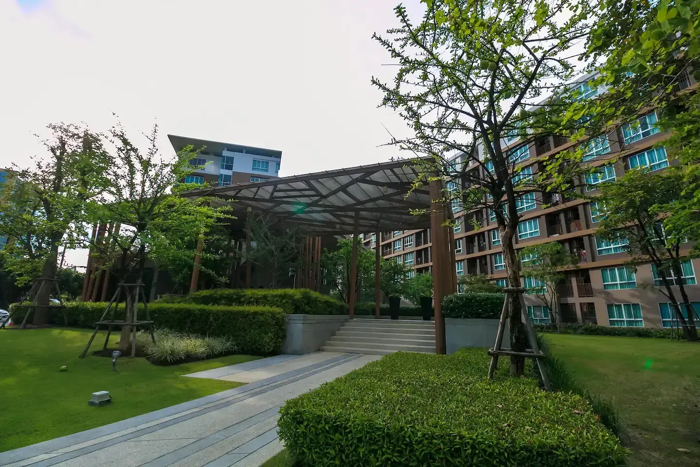 Manicured tropical gardens and pedestrian walkways in the complex