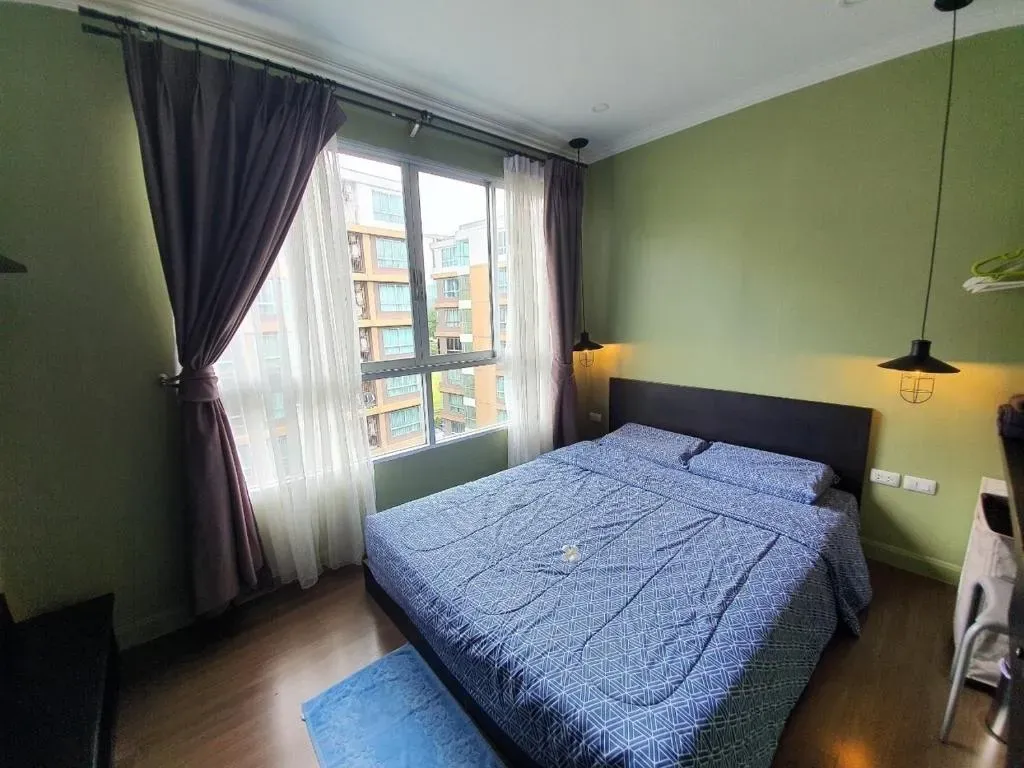 Bright apartment bedroom with comfortable double bed and large window